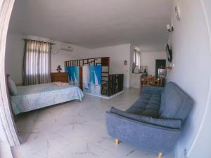 a living room with a couch and a bed at Cadets Studio in Mahébourg