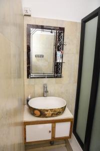 a bathroom with a sink and a mirror at Cadets Studio in Mahébourg +10 photos
