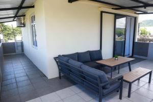 a patio with a couch and a table at Cadets Studio in Mahébourg