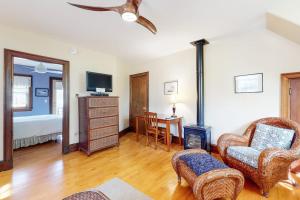 a living room with a couch chairs and a tv at Morning on the Atlantic in Portland