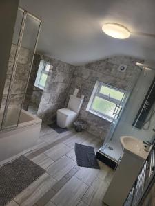 a bathroom with a tub and a toilet and a sink at Belvedere Bliss in Belvedere +18 photos