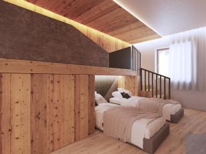 two beds in a room with wooden walls at al Ritrovo - rooms & more in Andalo