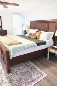 a bedroom with a large bed with a wooden headboard at Cozy Mountain Rancher in Harpers Ferry