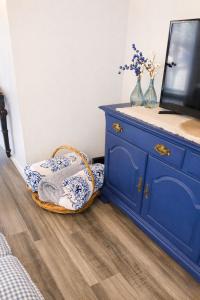 a blue dresser and a chair in a room at Cozy Mountain Rancher in Harpers Ferry