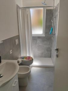 a bathroom with a toilet and a sink and a shower at La Casa di Mami in Velletri +19 photos