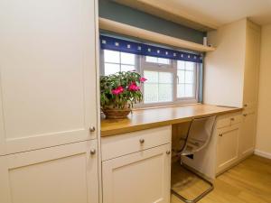 a home office with a desk and a window at The Apple Loft in Exeter