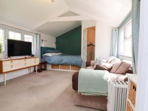 a living room with a couch and a television at The Apple Loft in Exeter
