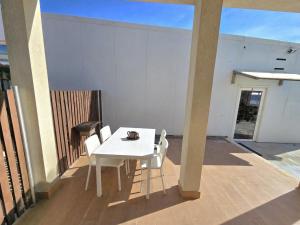 a white table and chairs on a balcony at Vikings AL in Areosa