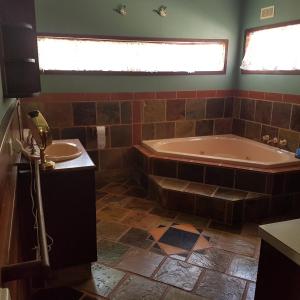 a bathroom with a tub and a sink at Chestnut Brae Farmstay - Chestnut Retreat in Nannup +51 photos