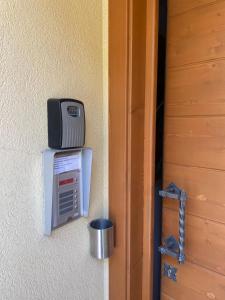 a door open to a room with a television on the wall at Agritur Affittacamere Capra Mauro in Carzano