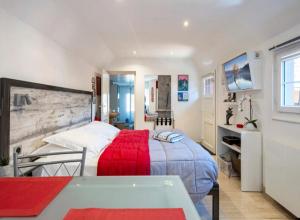 a bedroom with a large bed with a red blanket at La Cour Des Amis in Vendenheim