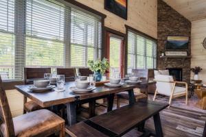 a dining room with a wooden table and chairs at Paradise Point in Pigeon Forge