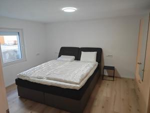 a bedroom with a large bed in a room at Ferienwohnung ERSO in Wutöschingen