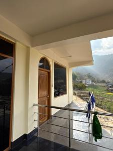 a balcony with a view of the mountains at E-RE House, Dirang in Dirang Dzong