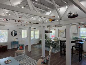a living room with a table and a dining room at The Cottage in Wilmington +23 photos