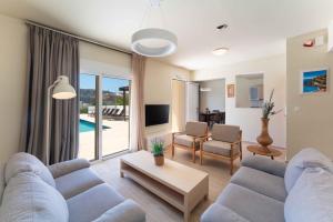 a living room with a couch and a table at Aethrion Villa Lindos in Lindos