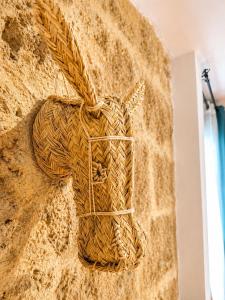 a wicker horse on a wall at La Rustiqueta Javea terraza BBQ casco antiguo in Jávea +40 photos