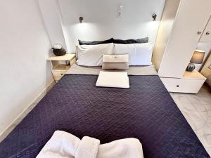 a bedroom with a large bed with white pillows at Xristinas Rooms in Lentas