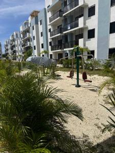 an empty playground in front of a apartment building at Estilo tropical 1 in La Romana
