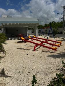 a row of playground equipment in front of a building at Estilo tropical 1 in La Romana