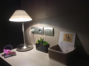 a desk with a lamp and a lamp post at Le Camere Di Nana' in Sanremo