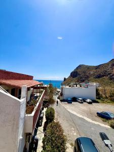 arial view of a street with buildings and the ocean at Xristinas Rooms in Lentas