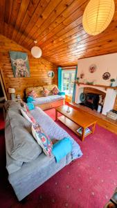 a living room with a couch and a table at Cabin Gezellig in Trawsfynydd