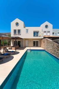 a villa with a swimming pool and a house at Aethrion Villa Lindos in Lindos