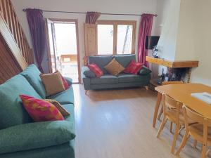 a living room with a couch and a table at SUITEDREAMS - Camp de Baix in La Massana