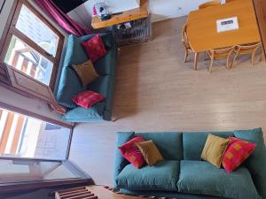 a living room with a blue couch and a table at SUITEDREAMS - Camp de Baix in La Massana +11 photos