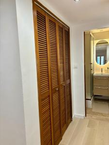 a bathroom with a wooden closet and a sink at L'Escale Auffan - Mourillon in Toulon +2 photos