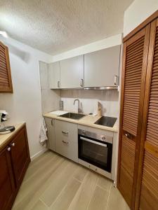 a kitchen with a sink and a stove at L'Escale Auffan - Mourillon in Toulon