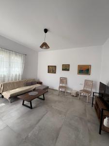 a living room with a couch and two chairs at NAXIAN OLIVE House in Glinado Naxos