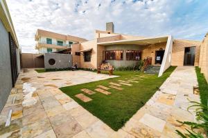 a house with a lawn in front of it at Luxury Oceanfront House - Beachfront - Pool in Aquiraz