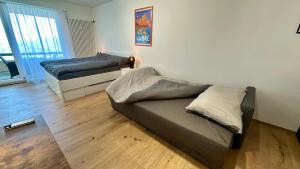 a living room with two beds and a couch at Bella-Lugano in Aldesago +21 photos
