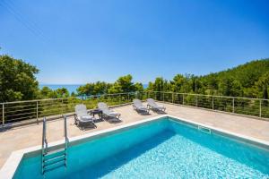 a swimming pool on the roof of a house at Villa Angela in Trapezaki