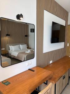 a bedroom with a bed and a mirror at Ammos Beach in Glida