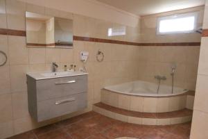 a bathroom with a tub and a sink and a bath tub at Jannas Home in Néa Karyá +41 photos