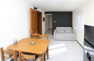 a living room with a table and a couch at Jannas Home in Néa Karyá