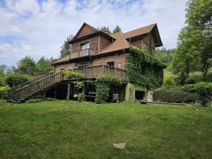 a large house with a deck on a lawn at Gałęziówka, Doły Biskupie in Kunów