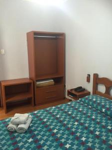 a bedroom with a bed with two towels on it at Hotel Regência in São Lourenço