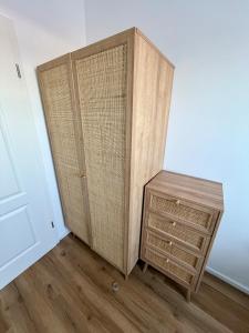 a bedroom with two closets and a wooden dresser at RheinStrand, wunderschöne, renovierte Wohnung in Dormagen