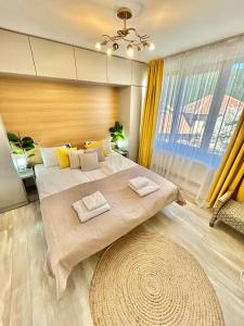 a bedroom with a large bed and a large window at Bulgarane House in Govedartsi