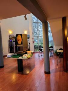 a living room with a table and a large window at Good Night Hotel in Arques