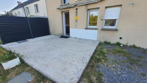 a concrete pad in front of a house at Hôtel proche Cherbourg Hôtel l'Eden à Brix in Brix