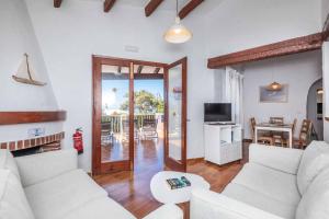 a living room with two white couches and a table at Villa Binisol in Binibeca