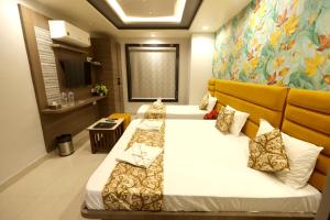 a hotel room with two beds and a sink at Hotel ELITE CHOICE in Ajmer