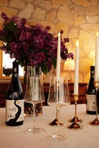 ein Tisch mit zwei Flaschen Wein und zwei Kerzen in der Unterkunft Iora Winery in Sagarejo