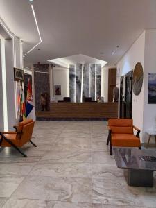 a lobby with two chairs and a couch at two seasons hotel in Bangui