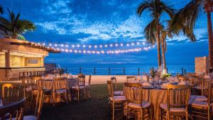 a wedding reception on the beach with tables and chairs at Park Royal Mazatlán in Mazatlán +71 photos